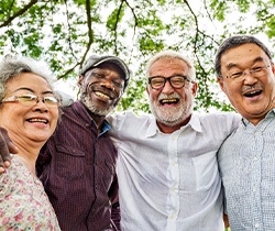 Coppell dentures patient smiling with friends