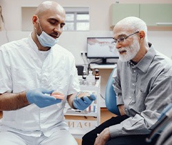 Coppell patient smiling confidently with new dentures