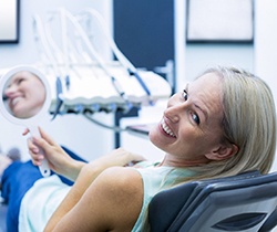 female patient smiling about her dental implant  