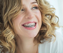Young woman with braces in Coppell smiling 