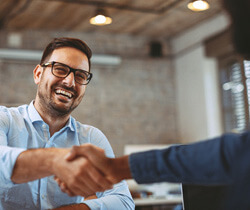 smiling person shaking hands