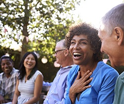 Diverse group of friends laughing with dental implants in Coppell