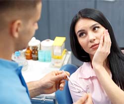 Pained woman visiting her Coppell emergency dentist