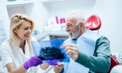 Dentist and patient discussing the cost of preliminary dental implant treatments in Coppell
