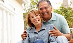 Couple smiles with dental implants in Coppell
