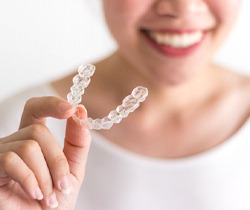 Woman holding clear aligner