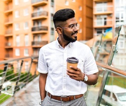 person holding a coffee and smiling