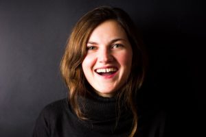 smiling young woman with gap between her two front teeth 