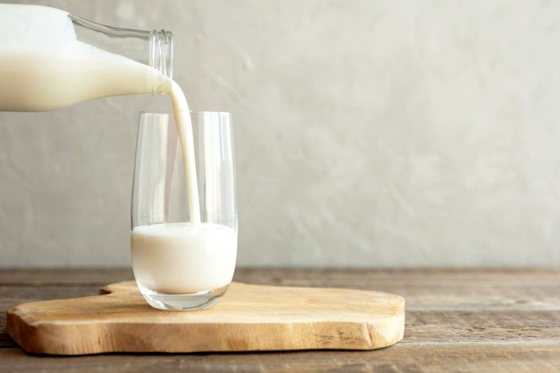 pouring milk into glass cup