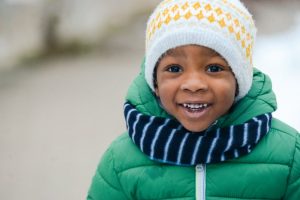 a boy with a healthy smile during the winter season