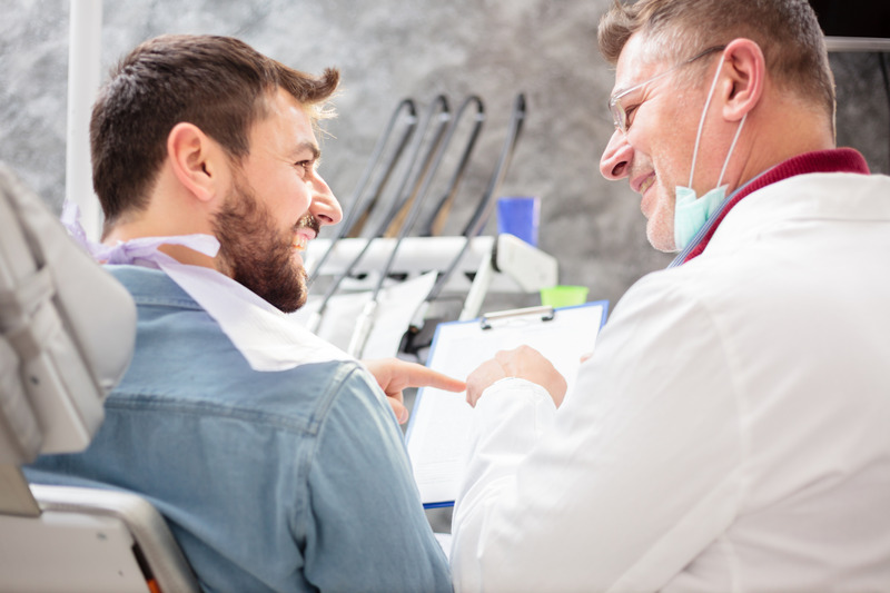 Patient smiling with dentist while planning cosmetic dentistry